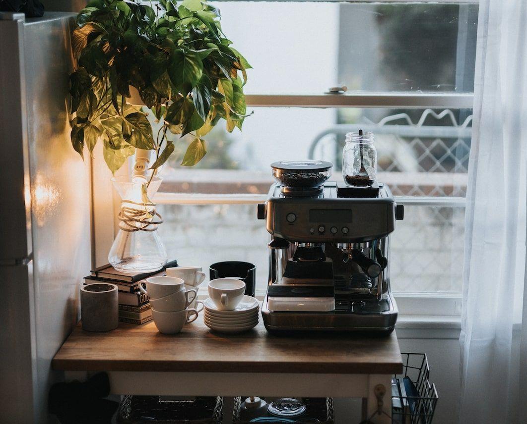 A coffee maker sitting on the counter in a kitchen.