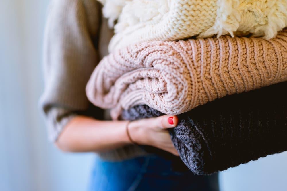 Woman holding folded laundry