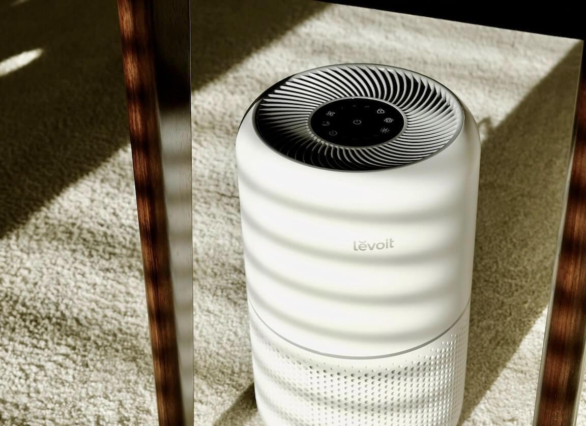 A small space heater being used in the corner of a room.