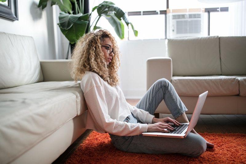 A woman checking her energy bill online in her apartment.