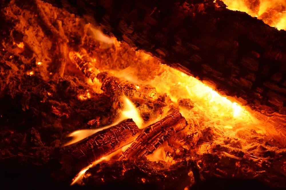 Closeup of a fire burning wood, which is a form of biomass energy.