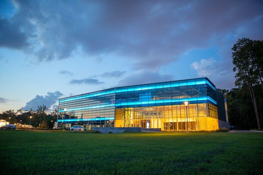 A corporate office building with all of its lights on.