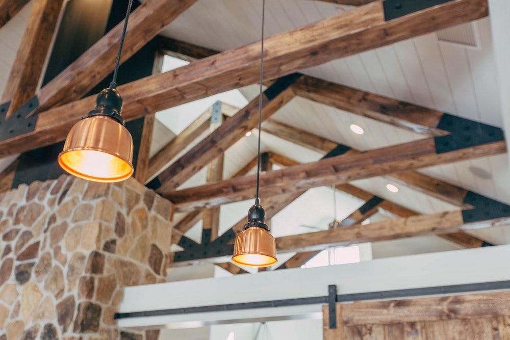 Lights hanging from the ceiling inside a rustic kitchen.